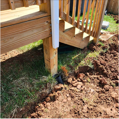 Site work and drainage near deck stairs